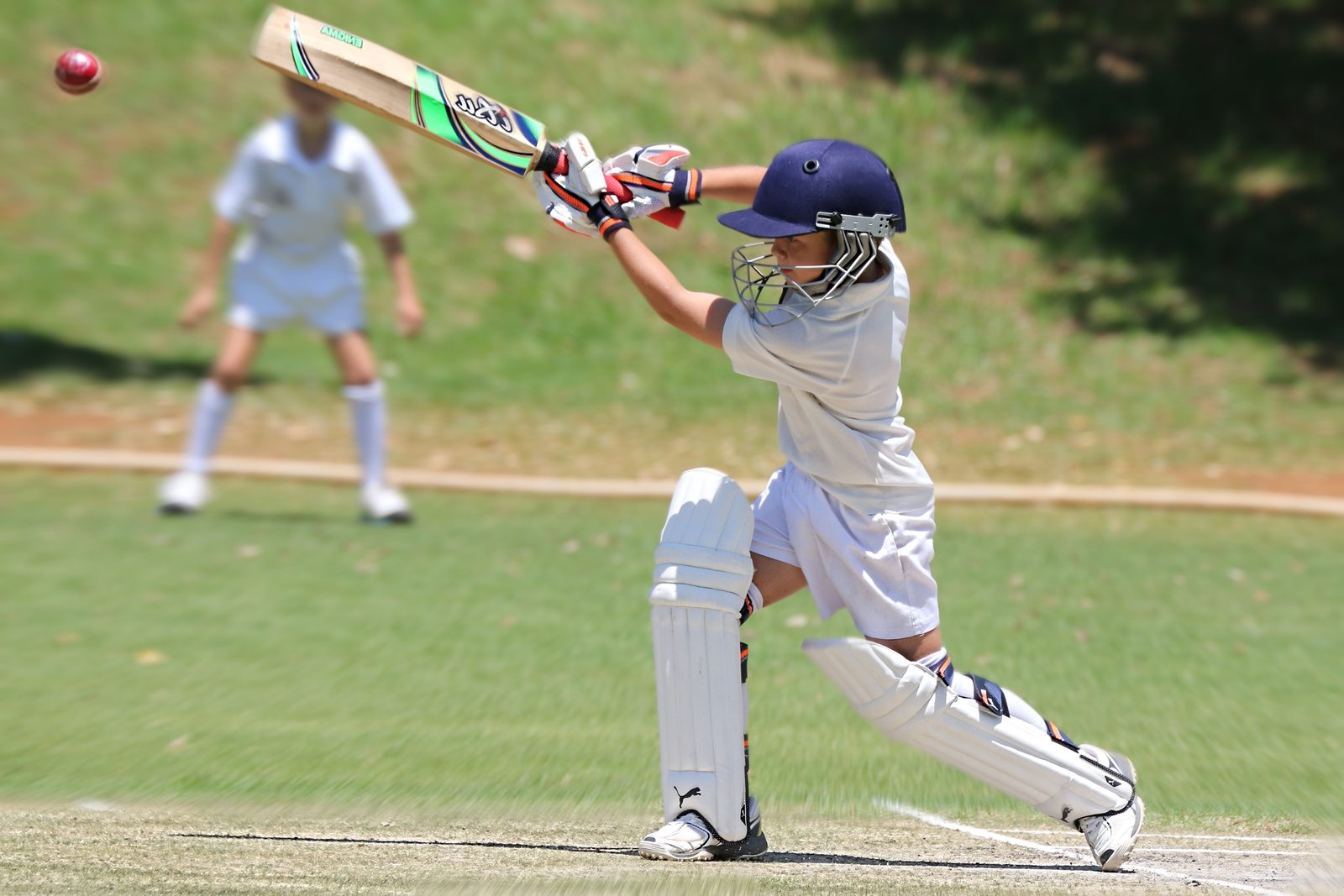 Young batter playing a shot